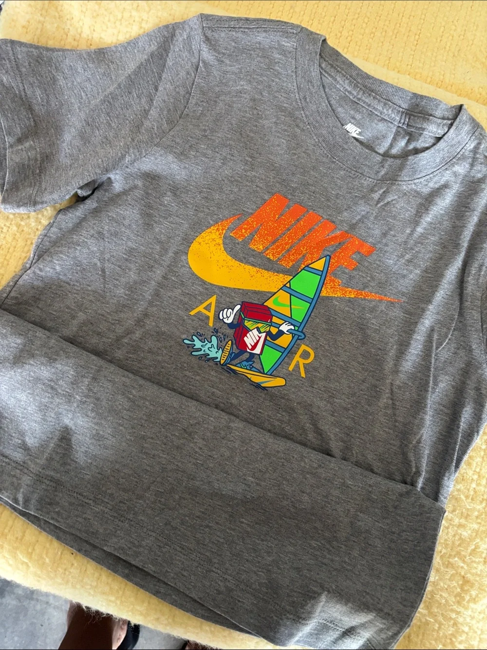 Nike Gray Short-Sleeve Tee with Yellow & Orange Logo and Colorful Surf Graphic